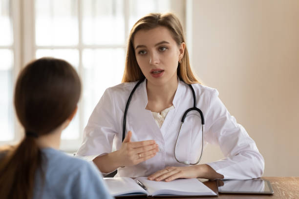 istock Focused confident young female general practitioner talking to patient. 1317036317