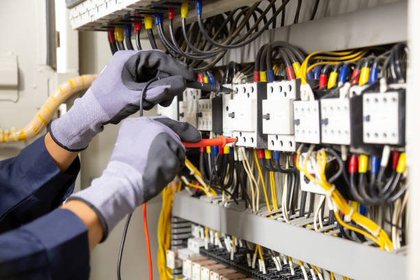istock Electrician engineer tests electrical installations and wires on relay protection system. Adjustment of scheme of automation and control of electrical equipment. 1317036320