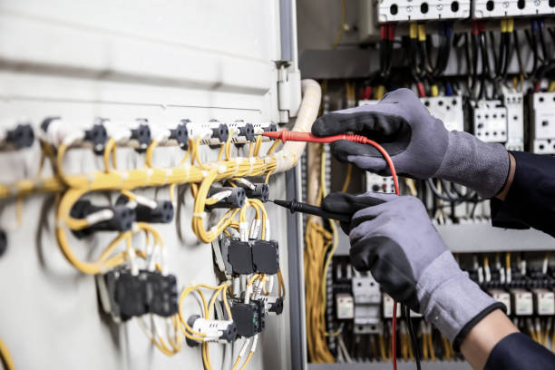 istock Electrician engineer tests electrical installations and wires on relay protection system. Adjustment of scheme of automation and control of electrical equipment. 1317036324