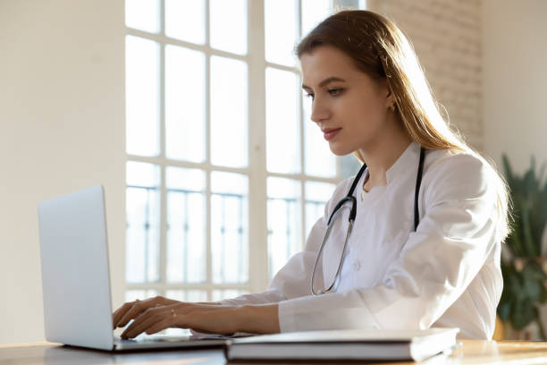 istock Focused millennial beautiful female physician working on computer. 1317036335
