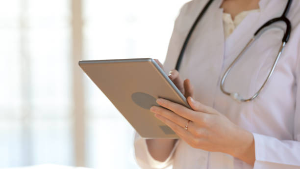 istock Close up young female doctor using digital computer gadget. 1317036338