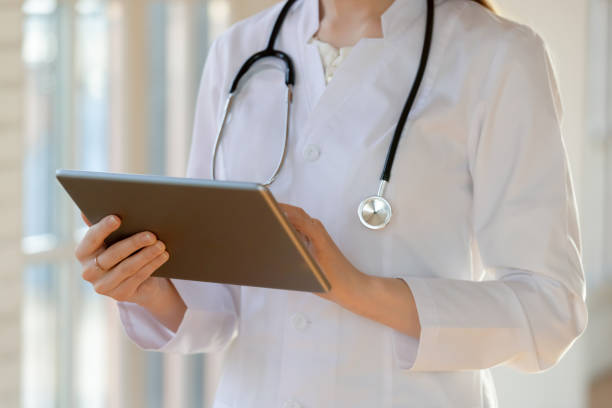 istock Close up female GP family doctor using electronic gadget. 1317036344
