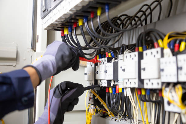 istock Electrician engineer tests electrical installations and wires on relay protection system. Adjustment of scheme of automation and control of electrical equipment. 1317036405