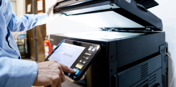 istock Bussiness man Hand press button on panel of printer, printer scanner laser in office copy machine supplies start concept. 1317036418