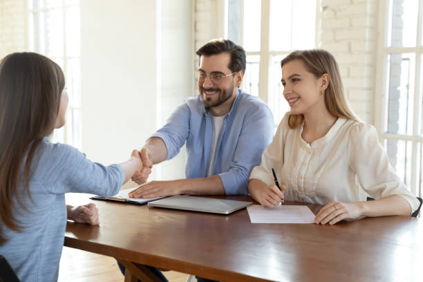 istock Smiling young human resources managers shaking hands with job applicant. 1317036420