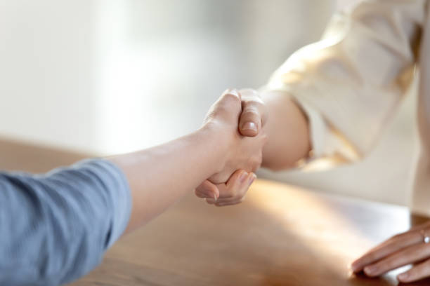 istock Close up two women handshaking, making business agreement. 1317036426