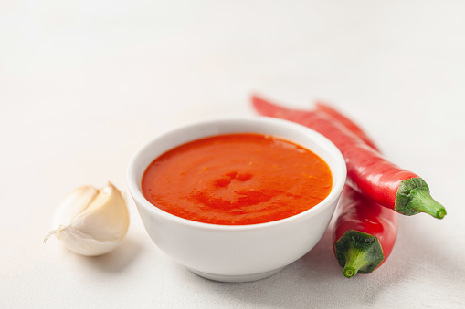 Freshly Sriracha Hot chilli Sauce in bowl on the table.