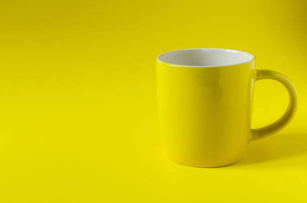 istock Abstract background yellow ceramic mug on yellow background close-up, concept. Bright yellow copy space mug 1317050254