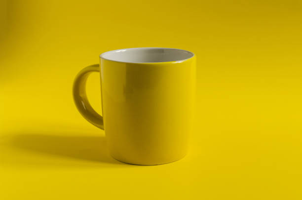 istock Abstract background yellow ceramic mug on a yellow background close-up, concept. 1317050256