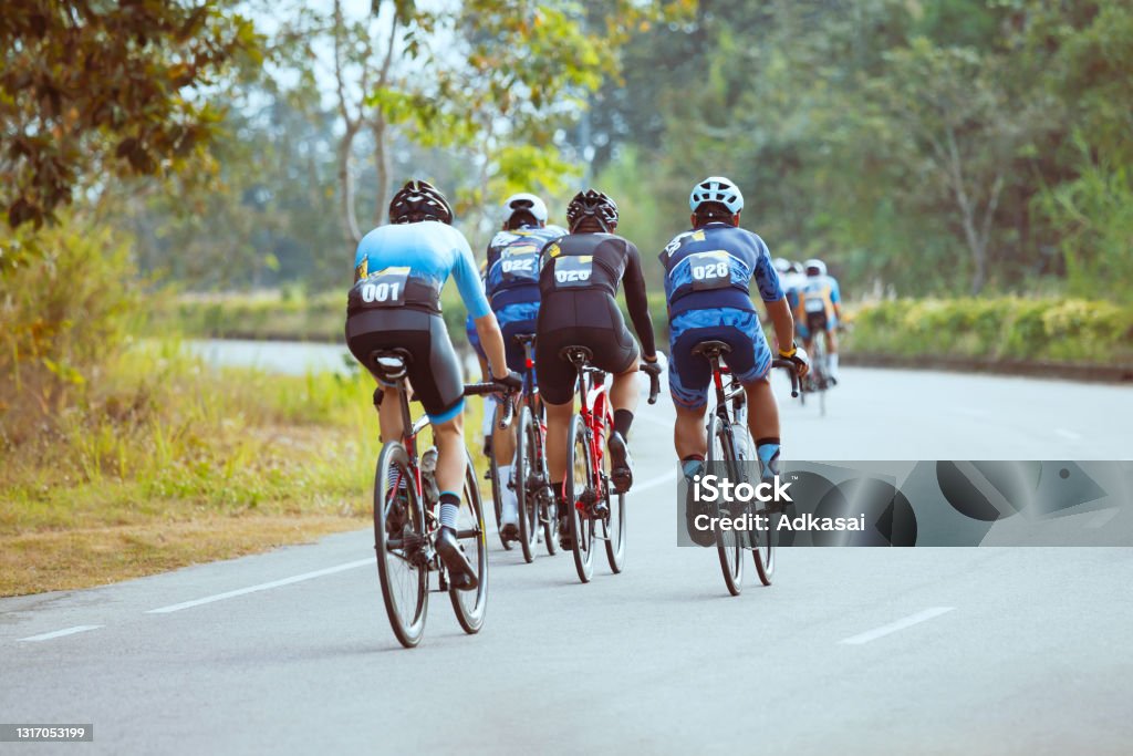 Group of professional cyclists during the cycling race Group of professional cyclists during the cycling race. Shot in back - Image Cycling Stock Photo
