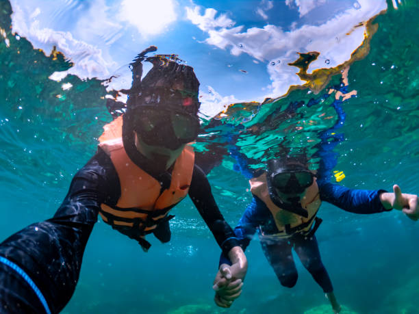 Happiness couple taking selfie under tropical sea