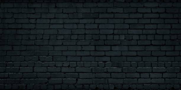 istock Black old brick wall widescreen texture. Dark brickwork abstract grunge industrial background 1317055058