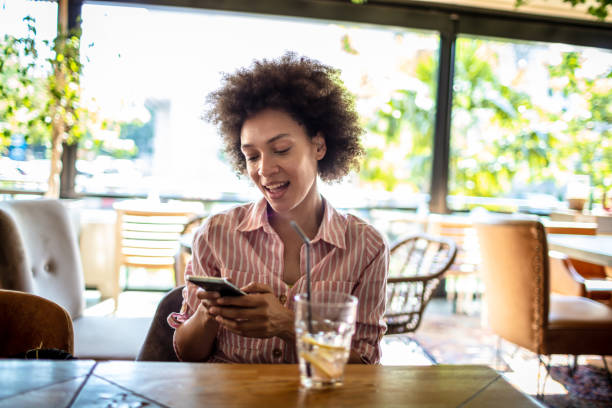 istock Woman using mobile phone at the Cafe bar 1317058154