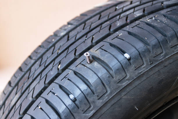 istock Screw in tyre stuck inside it, concept checked and removing 1317059232