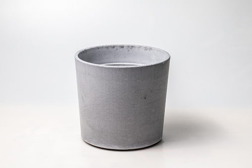 Grey color cement plant pot on white