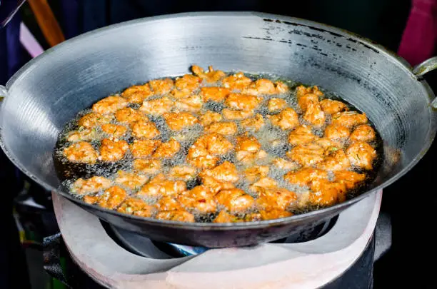 Thai traditional food well known as Todman, or fried fish-curry paste balls cooking