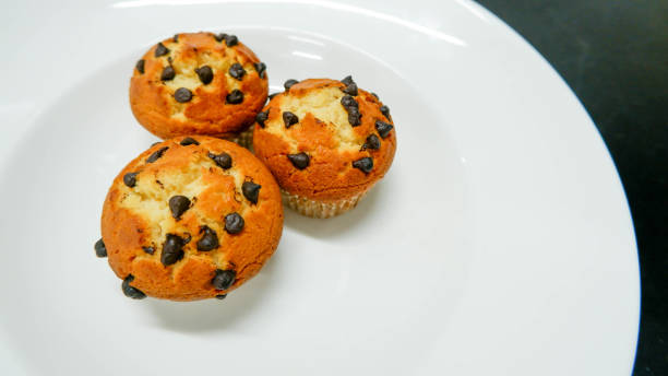 istock chocolate chip muffin on white plate 1317062189
