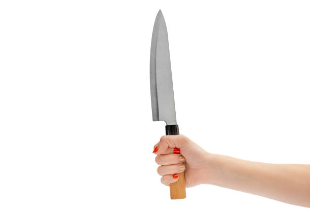 istock Woman's hand holding knife. Isolated on white. 1317062817