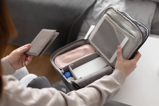 istock Female hands putting tablet pc into comfortable bag storage get ready to business trip or vacation 1317064671