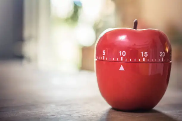 10 Minutes - A Red Kitchen Egg Timer In Apple Shape On A Table
