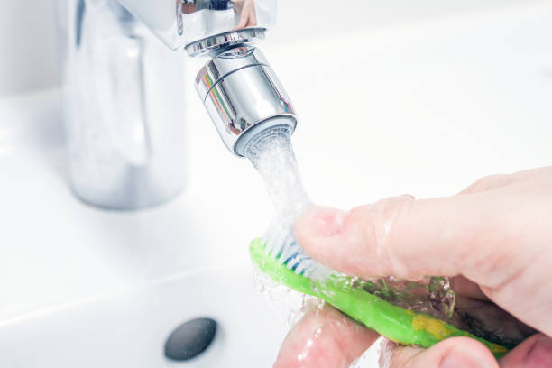 istock Cleaning A Toothbrush Under Pouring Water At Bathroom Sink 1317067437