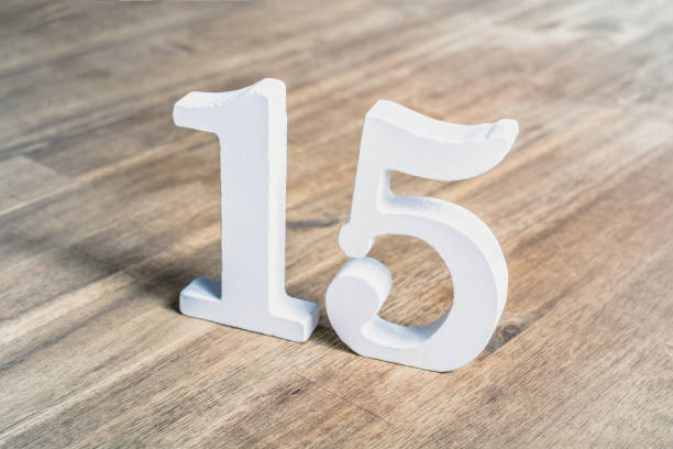 istock Number 15 Standing On A Brown Wooden Table 1317067568