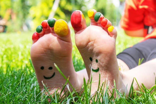 Kids feet with smiley faces drawings