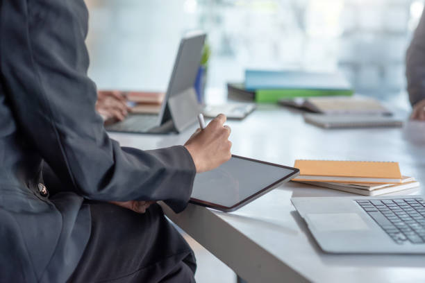 istock Businesswoman meeting sharing ideas together in the office using a tablet and documents placed on the table. 1317075822