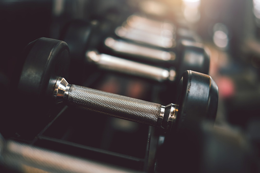 Close up of dumbbells placed at the gym.