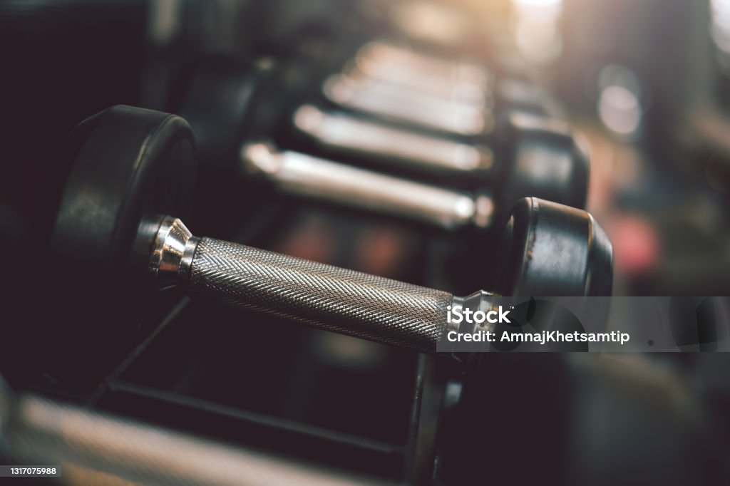 Close up of dumbbells placed at the gym. Weights Stock Photo