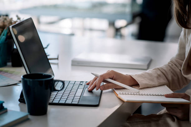 istock Image of working woman using tablet and taking notes at the office. 1317076003