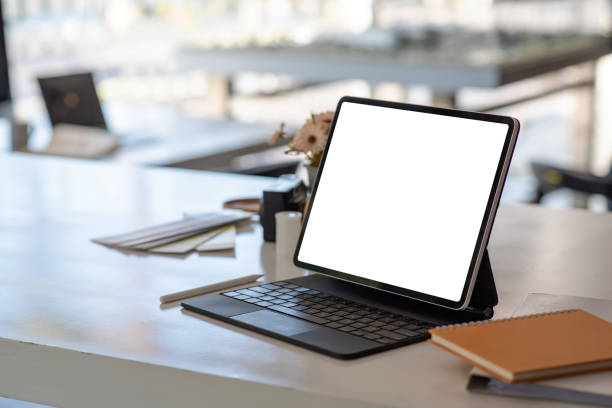 istock Laptop with white screen black keyboard and office equipment placed on the table. Mock up. 1317076009