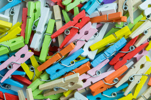 Colorful Clothespins or Laundry Clips Closeup of Wooden Colorful Clothespin or Laundry Clips for backgrounds clothespin wood stock pictures, royalty-free photos & images