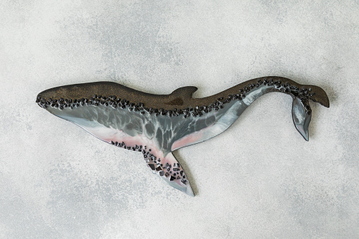 Resin art whale on gray background. Epoxy art. Flat lay