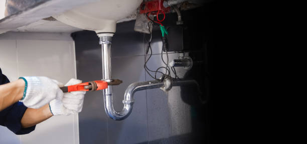 istock Plumber fixing white sink pipe with adjustable wrench. 1317081407