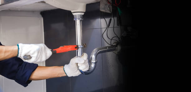 istock Plumber fixing white sink pipe with adjustable wrench. 1317081410