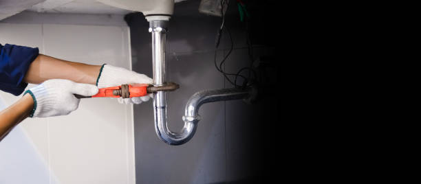istock Plumber fixing white sink pipe with adjustable wrench. 1317081415