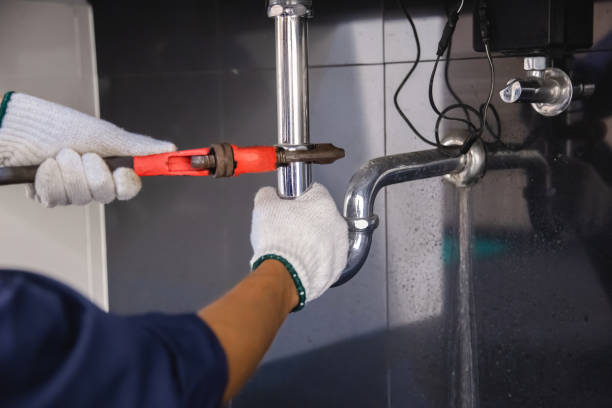 istock Plumber fixing white sink pipe with adjustable wrench. 1317081431