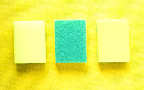 istock Three yellow sponges on yellow background. 1317081593
