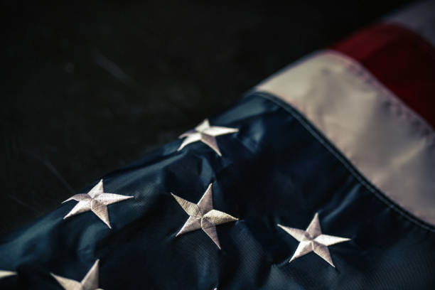 istock Flag of USA on dark background 1317082543
