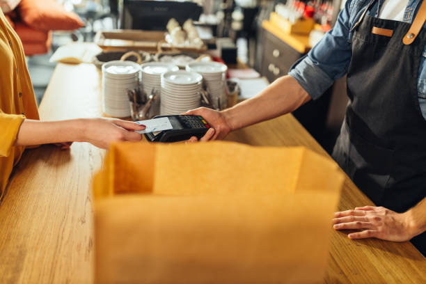 istock Customer paying bill with NFC technology in cafe 1317084058