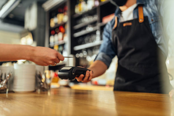 istock Customer tapping his card to make a payment in a cafe 1317084577