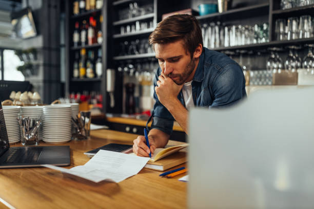 istock Male owner checking bills in cafe 1317085303