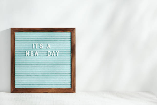 istock It's a new day. A letter board with a motivating phrase stands on the table. Morning sunlight with shadows. 1317086191