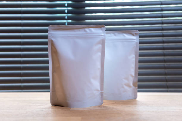 istock White Kraft Paper Bag,coffee bag package on wooden table. 1317090112