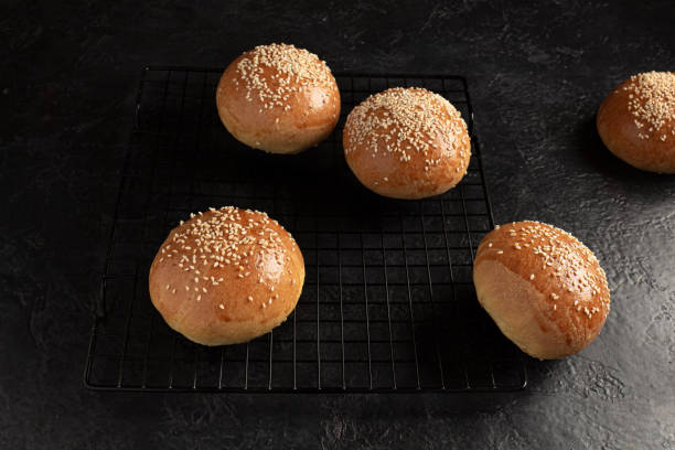 istock ready-made burger buns on a wooden cutting board. Home cooking 1317090131