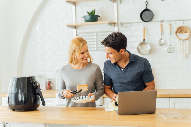 istock Woman working with airfryer and man using laptop 1317092082