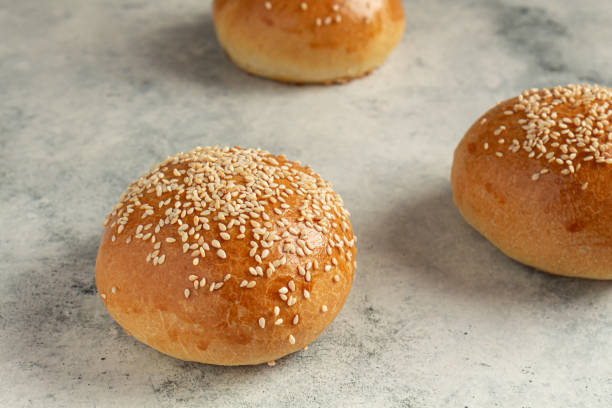 istock ready-made burger buns on a gray background. Home cooking 1317092770