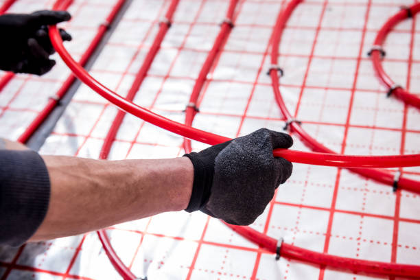 istock Pipefitter install system of underfloor heating system at home 1317092945