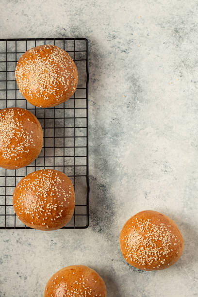 istock ready-made burger buns on a gray background flat lay. Home cooking 1317093989